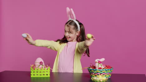 enthusiastic young girl playing peek a boo in front of camera