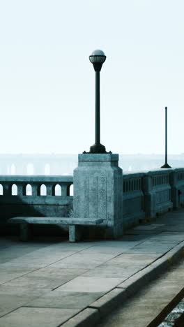 a bench on a bridge in the fog