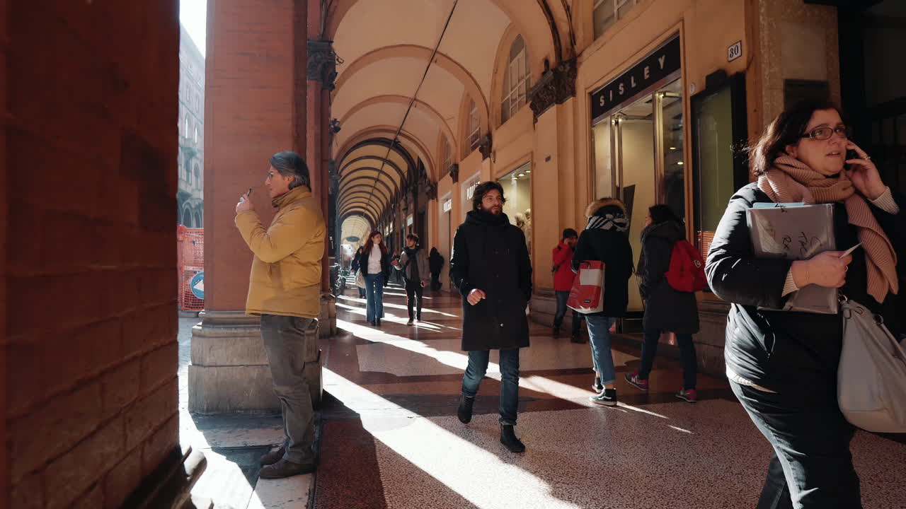 이탈리아 의 아케이드 에서 고 있는 사람 들