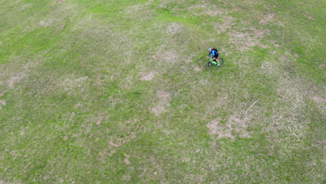 mountain biker rider travelling down a steep, grassy hill in the countryside of liptov, slovakia