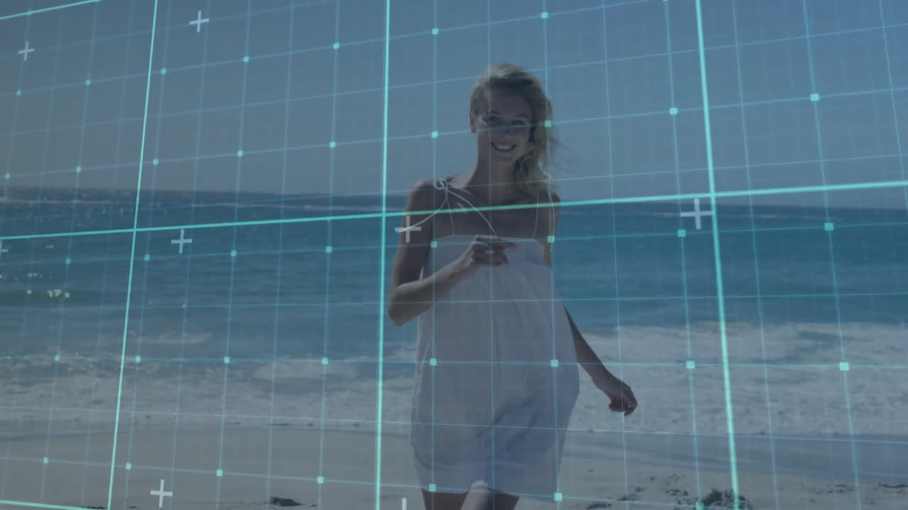 At beach, woman smiling with digital grid animation overlay in background