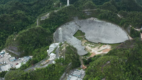 Dolly-out-shows-ongoing-deconstruction-of-parabolic-antenna-dish-at-Arecibo-Observatory,-Puerto-Rico