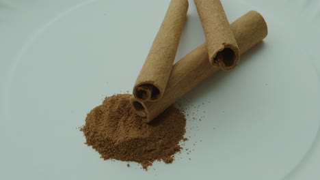 close up pan right of cinnamon sticks and ground cinnamon