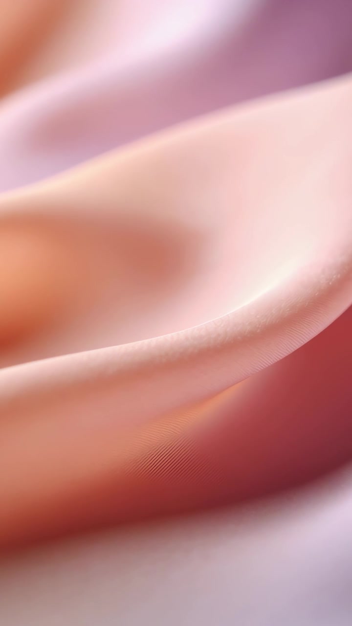Vertical video: Shifting silk-like drapery showing soft ripple after subtle light change in studio