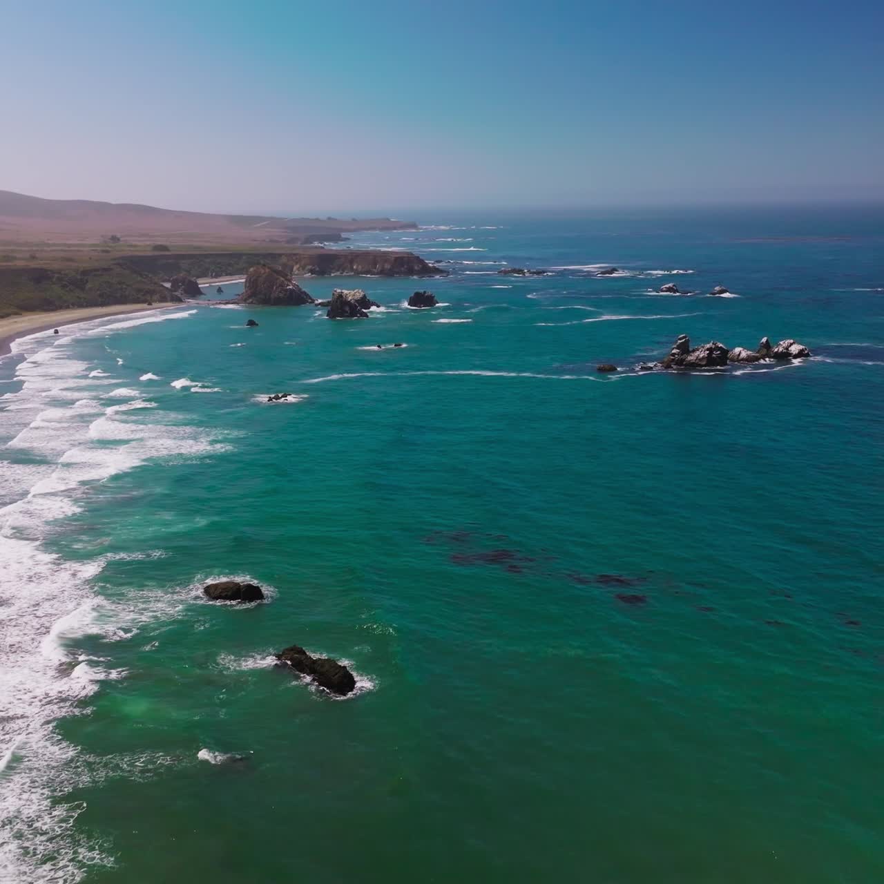 Amazing view of azure scenery of the ocean. Lovely sight of waves arriving to the rocky coastline of Morro Bay, California, USA