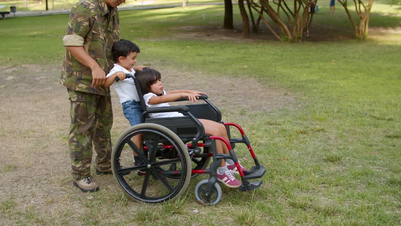 padre militar caminando con hijo e hija discapacitada