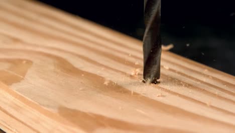 Nail screwing into wood
