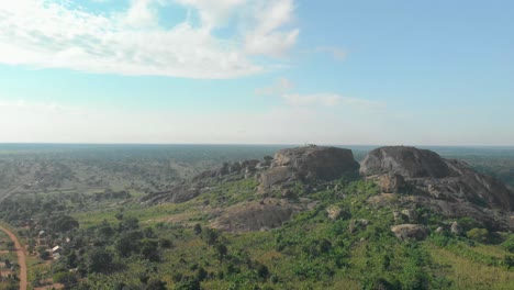 aerial shot orbiting around large granite boulders on the beautiful landscape of east africa