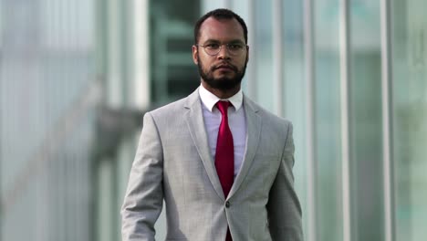 confident manager wearing suit walking on street