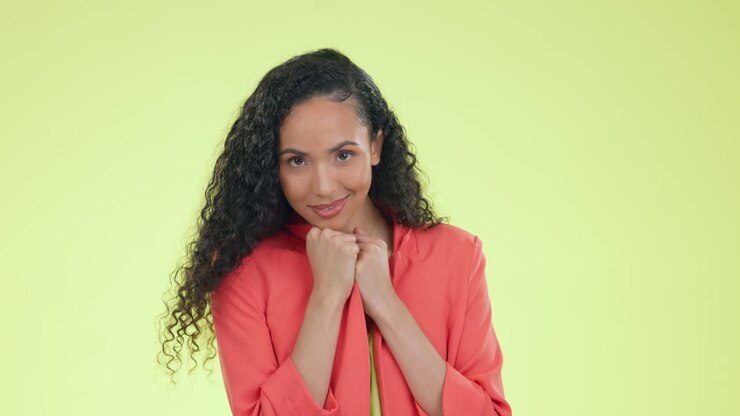 Happy, smile and shy with woman in studio