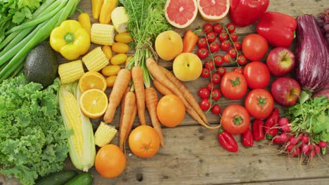 video of fresh fruit and vegetables over wooden background