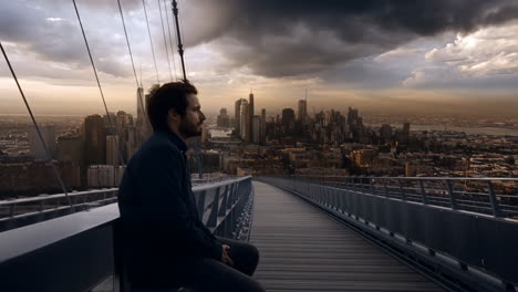 man on a bridge overlooking a city