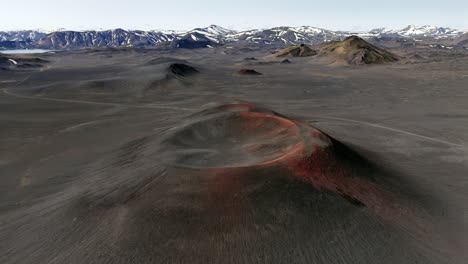 Cinematic aerial drone view of volcanic craters and lava fields in Iceland highlands, barren volcanic desert, rugged mountains and dramatic Nordic landscape, nature and geology background