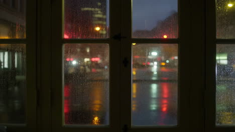 rainy night city view through a window