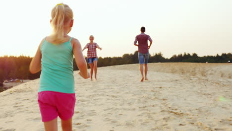 girl playing with his parents runs them through the sand on the beach prores hq 422 10 bit video