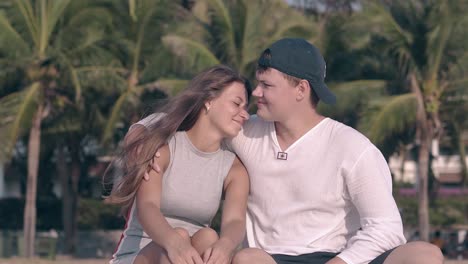 guy in cap comes to girl with long hair hugs and talks