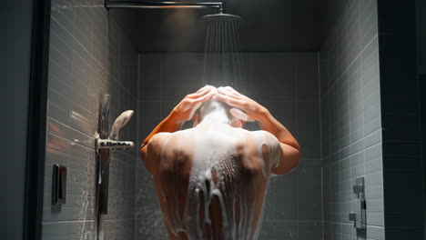 man showering with soap