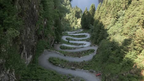 top down drone flight at kossdalssvingene revealing the incredible hairpin turns in osterøy, norway