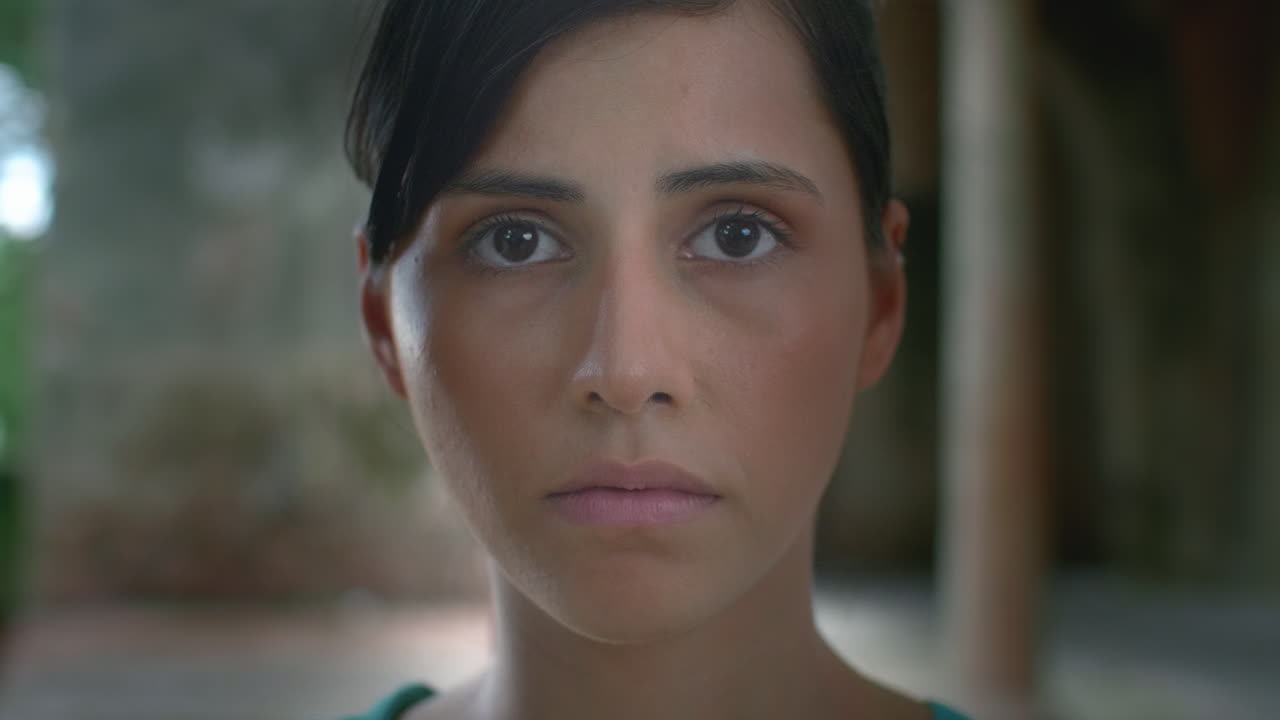 High-quality 4K footage of a serene young woman with closed eyes, then slowly opening them to look forward. Shot in natural, soft light. Ideal for meditation, mindfulness, focus, awakening