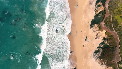 Slow-motion-seaside-turquoise-water-and-waves-at-sandy-beach