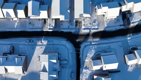 Roofing-over-snowy-winter-neighborhood-in-America-at-sunset