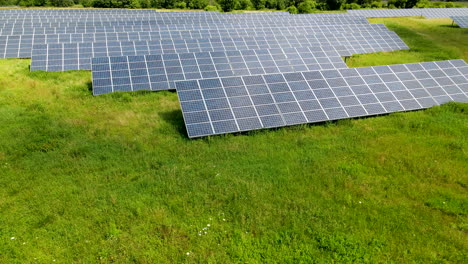 backward-aerial-Solar-panel-farm-in-Poland,-green-renewable-energy-from-solar-panels-in-Poland