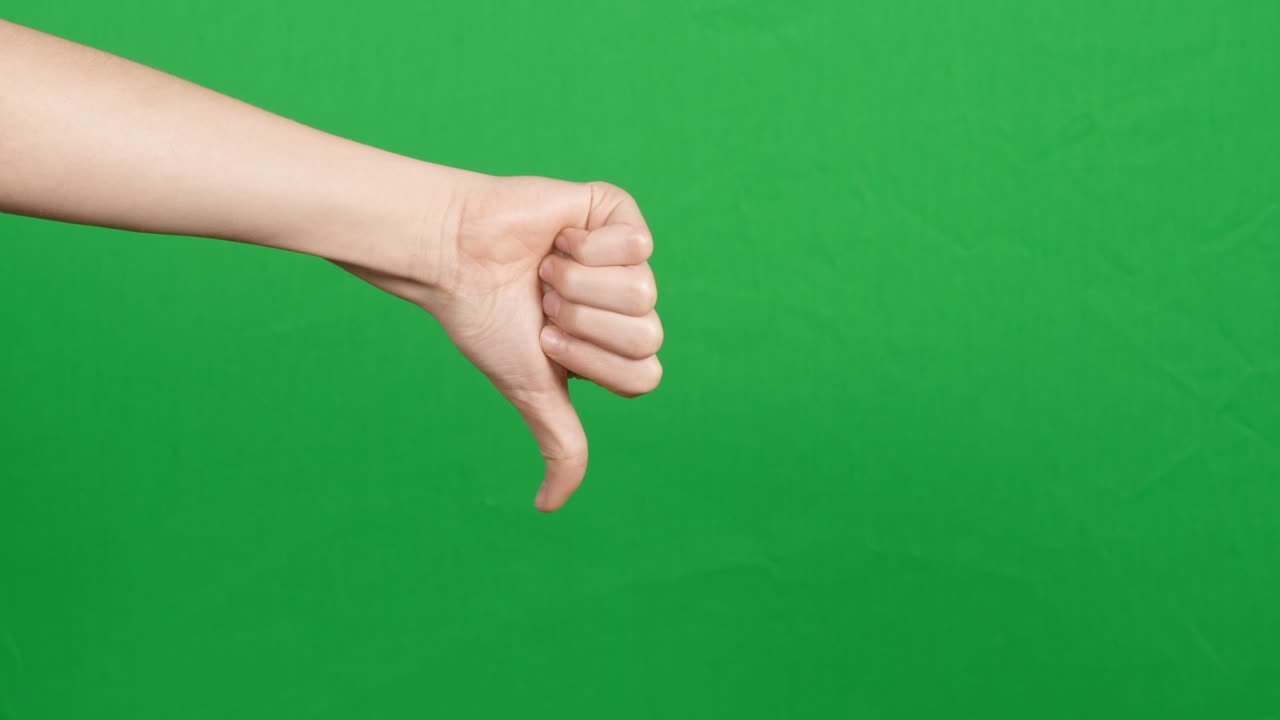 Like dislike gestures. Hand showing thumbs up, like, ok sign and change to thumbs down, dislike or negative sign symbol over green screen chroma key background