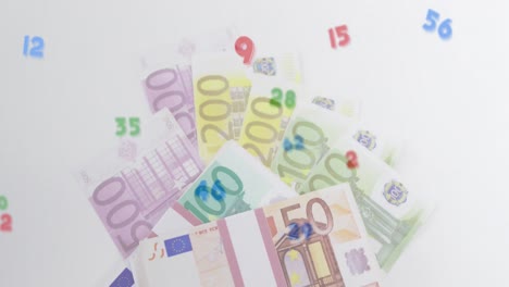 digital composition of multiple numbers and symbols floating against euro bills