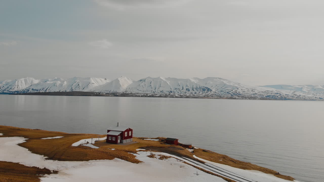 Red House by the Fjord in Iceland Winter Landscape