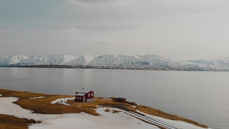 red house by the fjord in iceland winter landscape