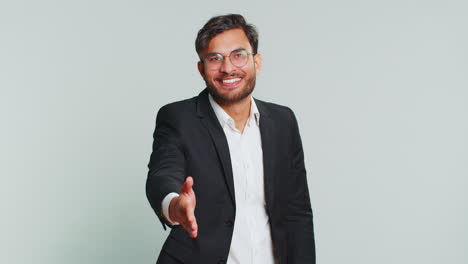 indian young man outstretching hand to camera, offering handshake, greeting, invitation, welcoming