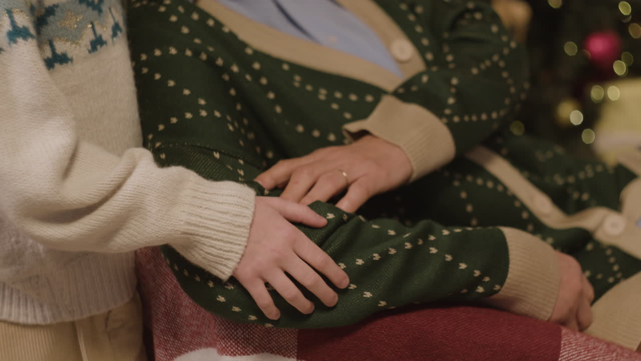 A heartwarming moment between grandmother and granddaughter by the Christmas tree