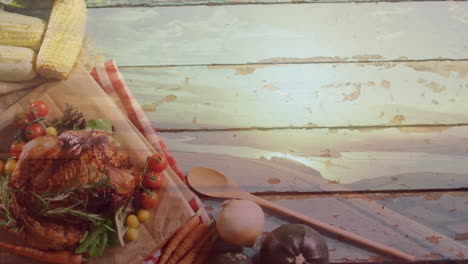animación de paisaje sobre pavo y verduras sobre fondo de madera