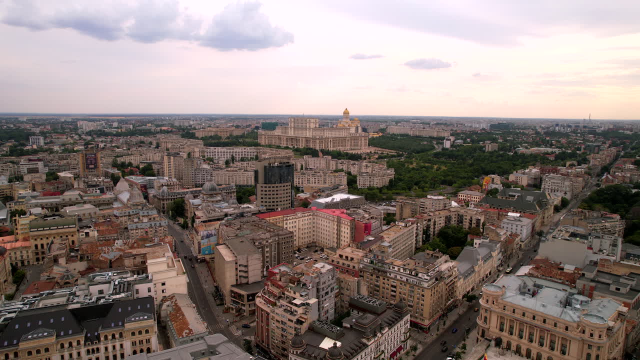 Romanian Parliament huge building in Bucharest at sunrise. Aerial dolly out