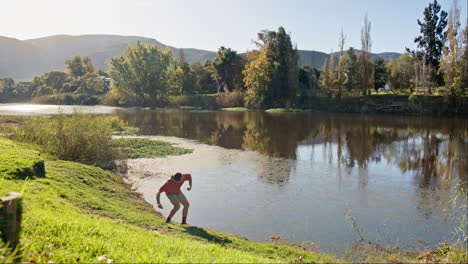 Nature,-man-and-throwing-rocks-into-a-lake