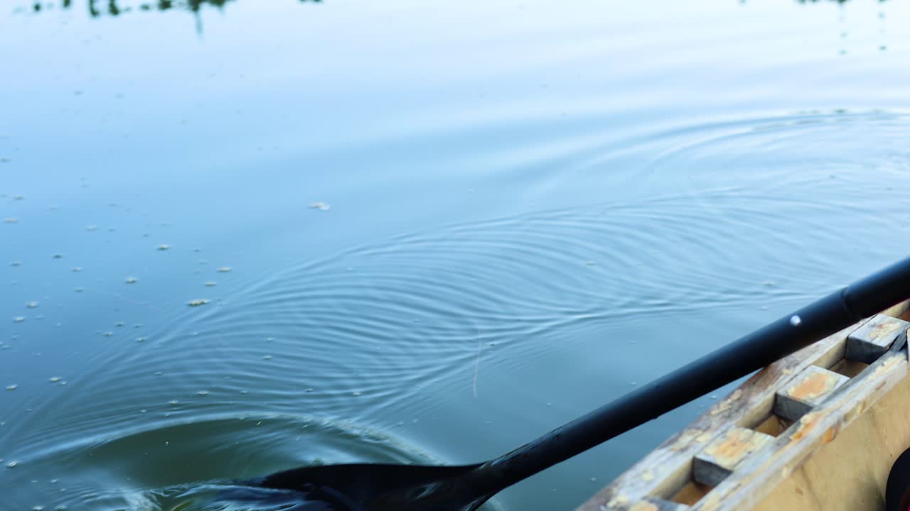 Sequence of a kayak paddle moving through water