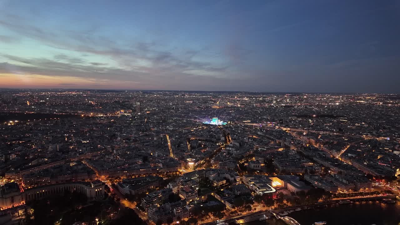 Paris city at night, France aerial view buildings light up landscape panorama skyline