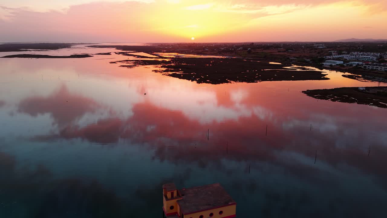 Aerial shot above the life boat station in Fuseta ans Ria Formosa natural park in Algarve region at sunset with beautiful colors, Portugal