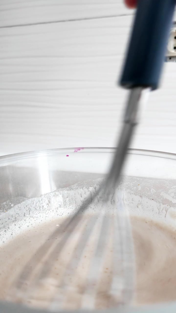 Mixing water and flour to make bread dough