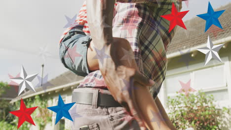 animation of red, blue and white stars over african american father and daughter having fun