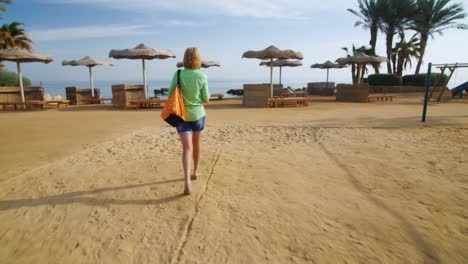 Steadicam-Shot-Tourist-With-A-Beach-Bag-Walking-Down-The-Beach