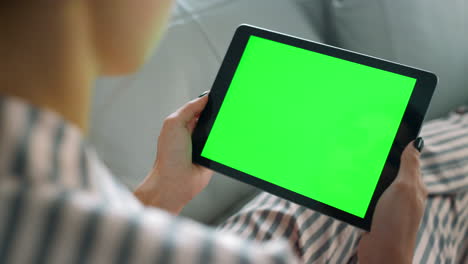 Girl-watching-green-tablet-screen-closeup.-Student-resting-on-sofa-enjoy-blog