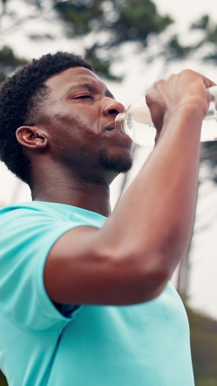 Young Man Drinking Water After Outdoor Workout
