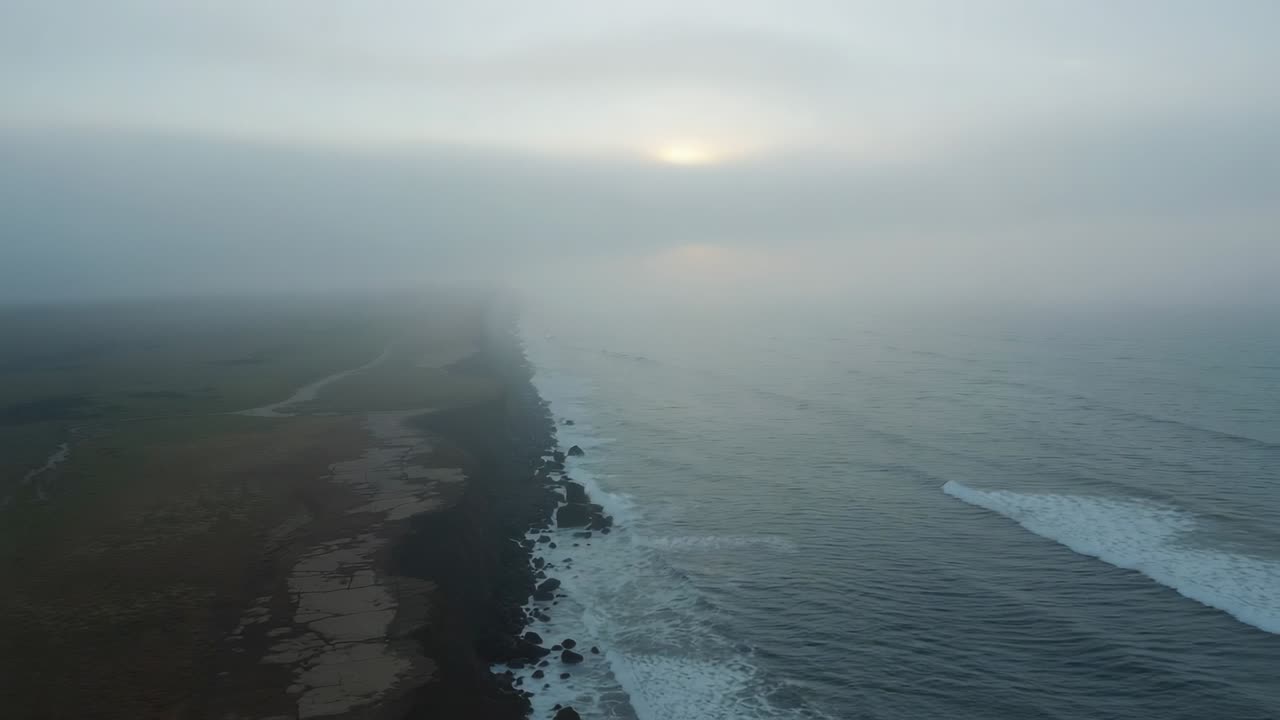 Drone initiating coastline survey over rocky coast, capturing jagged cliff edge and rolling waves