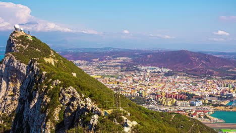 Timelapse-shot-of-a-soccer-ball-shaped-tower-on-top-of-a-hill-surrounded-by-the-Mediterranean-sea-in-Gibraltar-peninsula,-British-Overseas-Territory