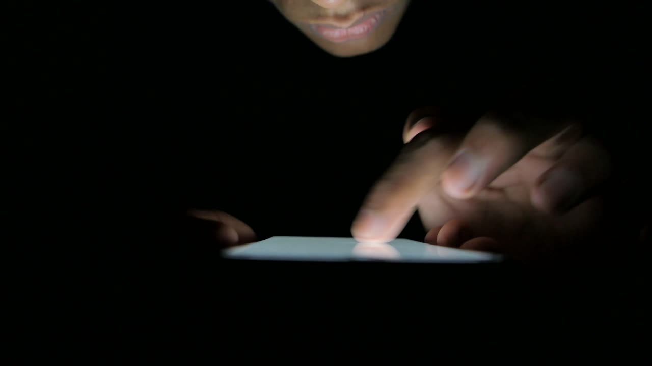 Person Using Mobile Phone at Night
