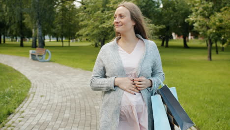 Pregnant Woman Shopping in the Park