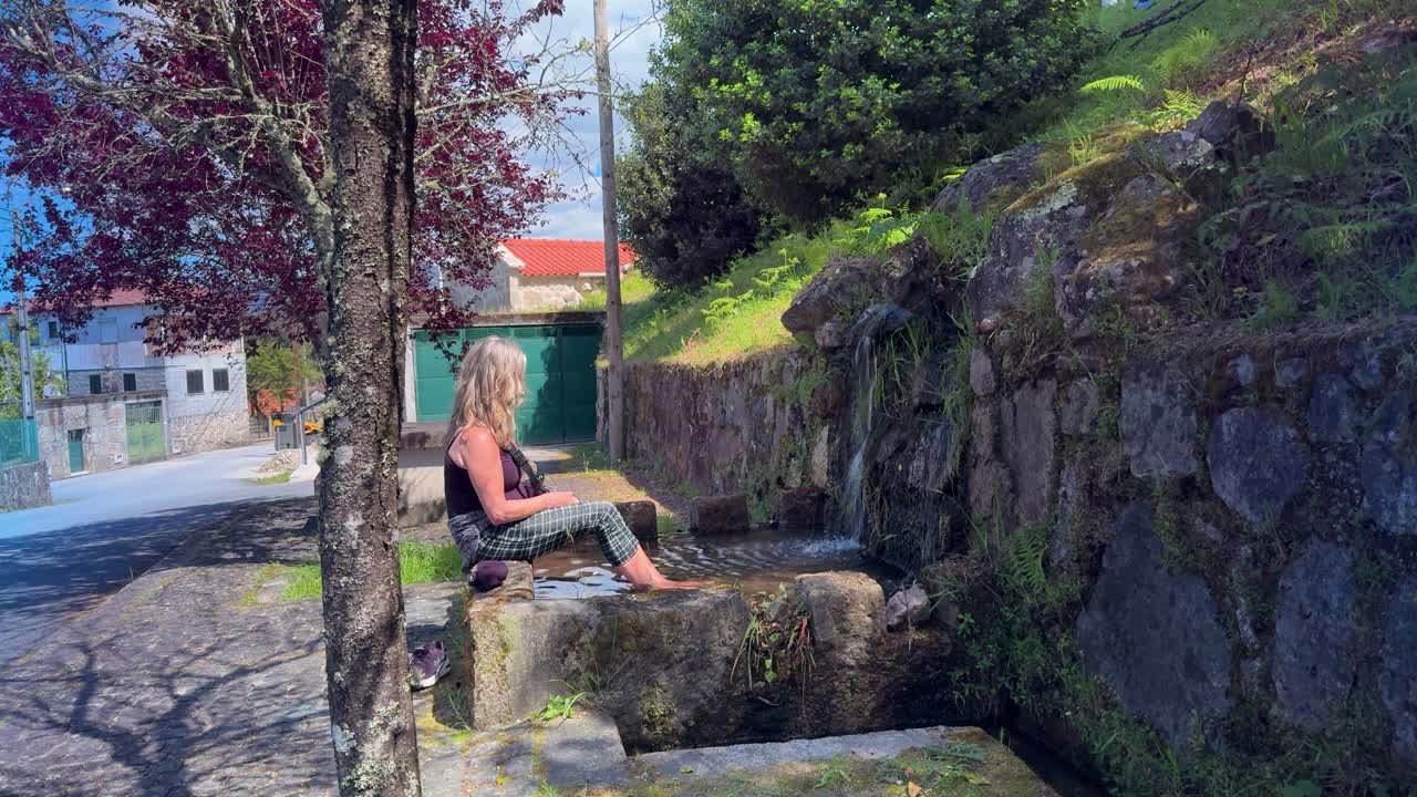 Taking a cold mountain water footbath after a long walk.