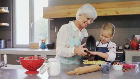 happy grandmother and granddaughter preparing pie 4k