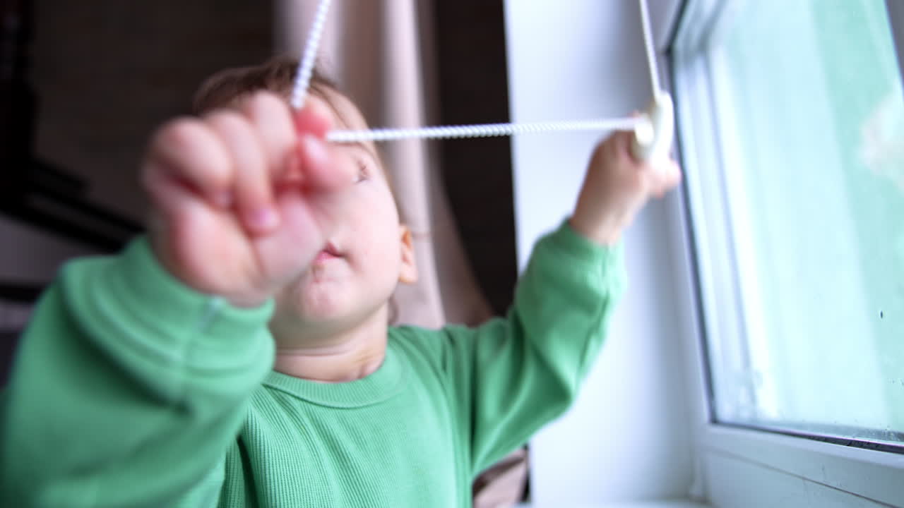 Baby Playing with Window Blinds